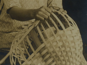 detail of a woman weaving an oak basket